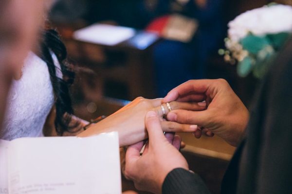Groom puts his ring on the finger of his bride a lovely wedding bands for couple