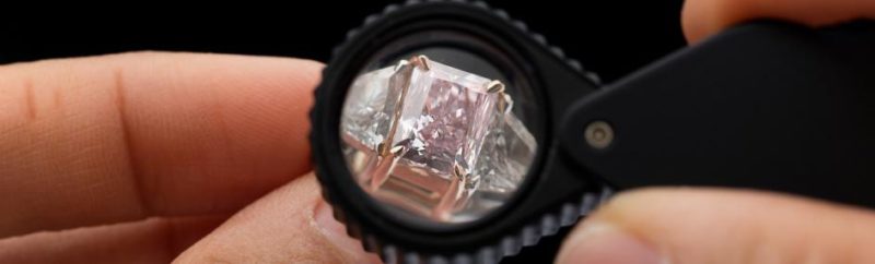 View of loupe's lens checking a fake diamond