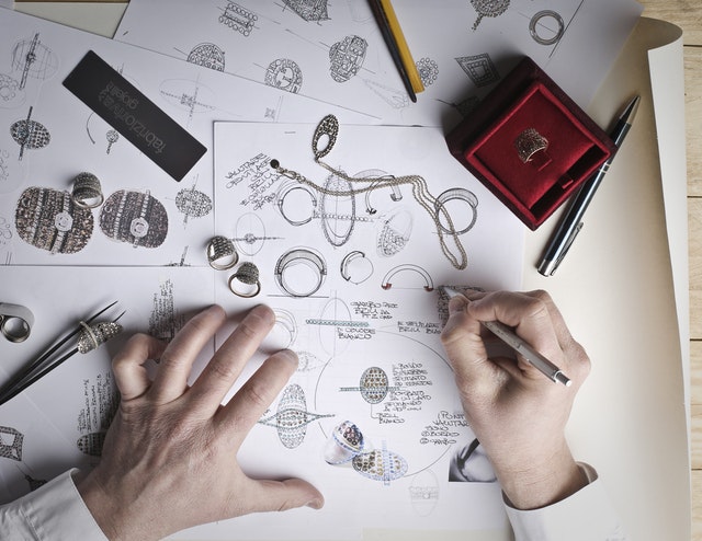 View of a jeweller's hands designing differemt types of jewellery