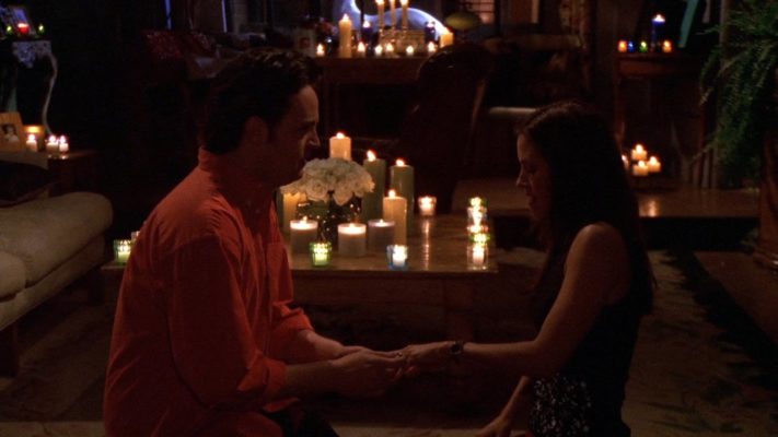 A romantic tv shows proposal scene of Chandler carefully wears Monica a ring from the tv show, "The One with the Proposal"