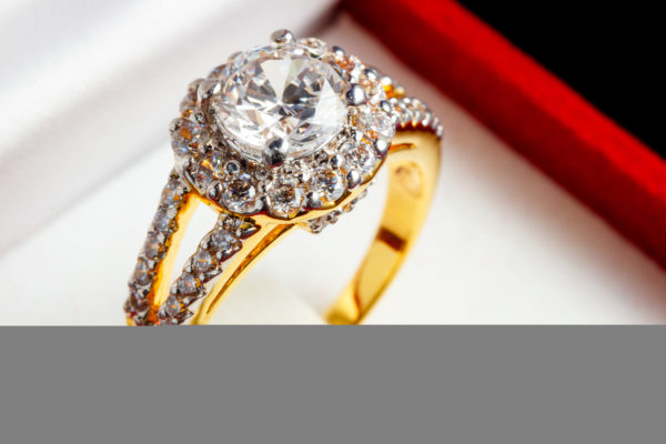 Split shank diamond engagement ring care surrounded by small diamonds