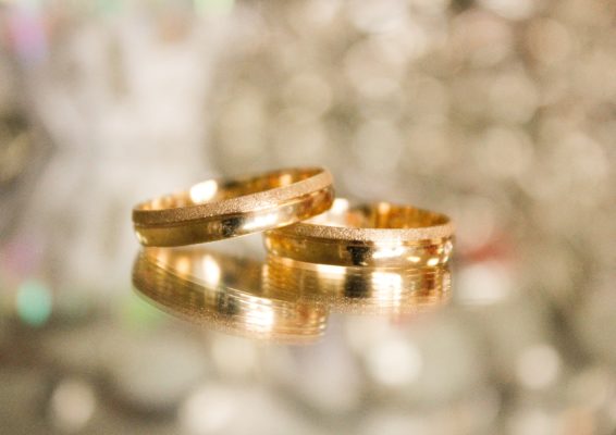 Close up view of wedding rings leaning on each other
